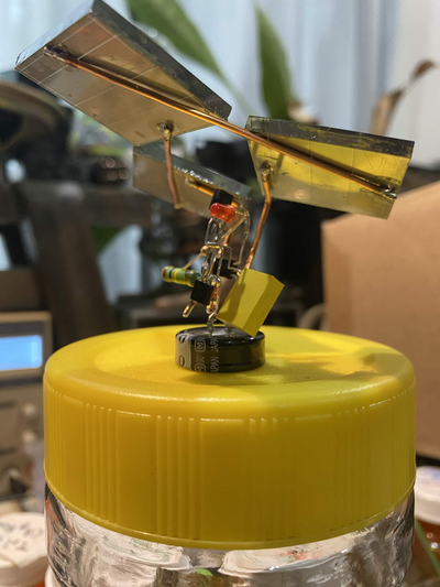 same as above photo, though with the little device rotated so you can see the free-form circuitry built with the component leads shaped to build a circuit in free space
